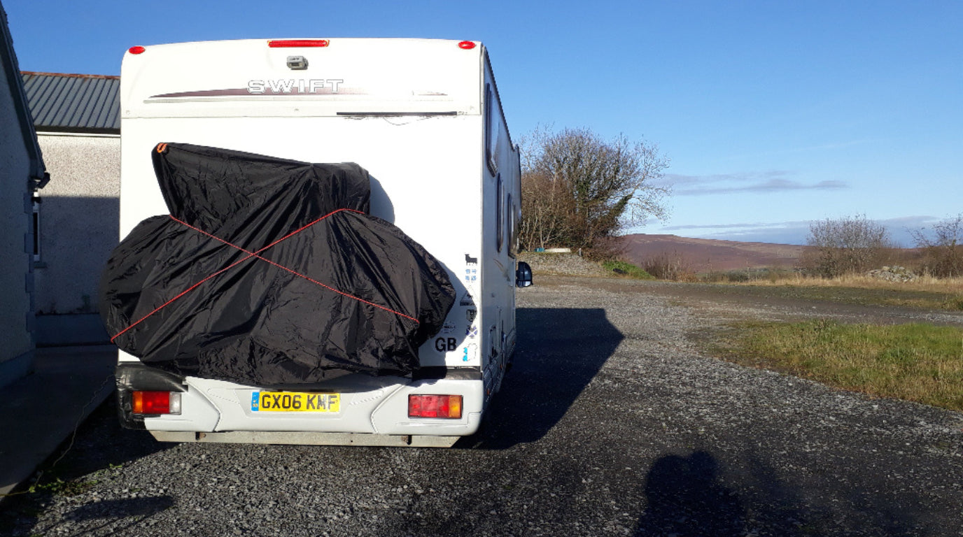 motorhome with a bike back and bike cover on the back