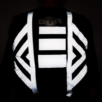 Waterproof hi vis black backpack cover with reflective tape. Night time visibility lifestyle image