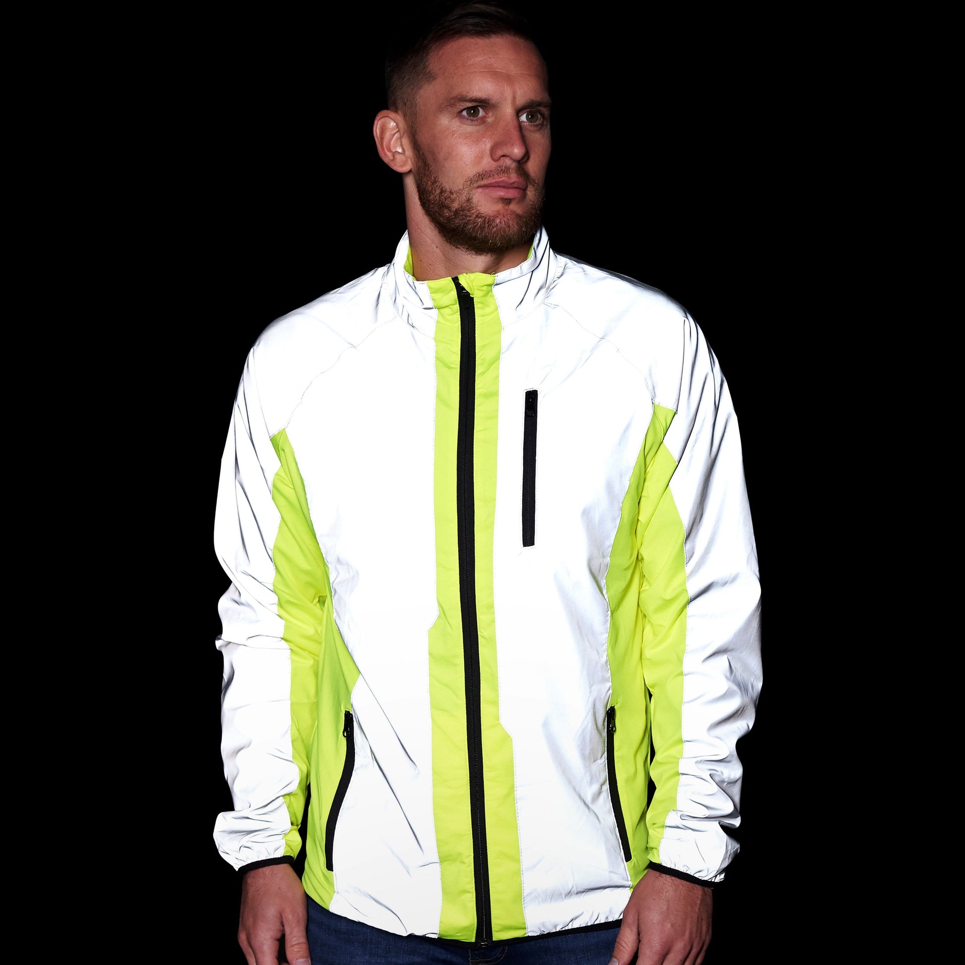 BTR reflective cycling and running jacket glowing bright white in the dark, worn by a man