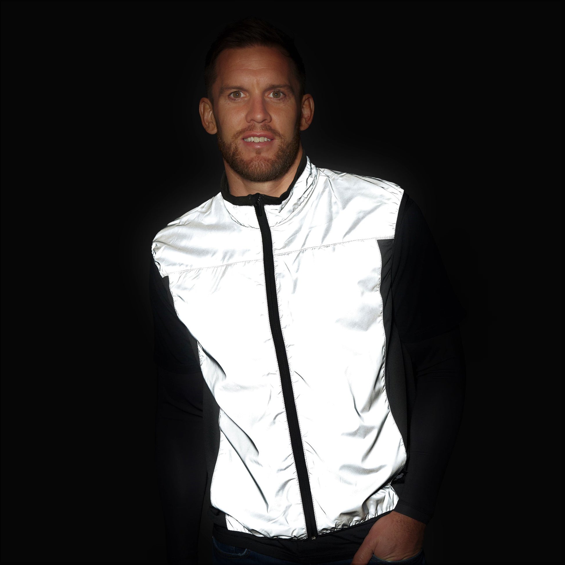 BTR silver reflective gilet glowing bright white in the dark, worn by a man