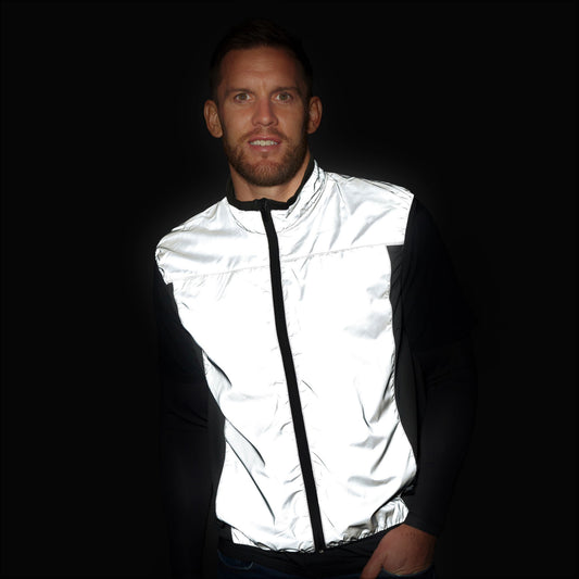 BTR silver reflective gilet glowing bright white in the dark, worn by a man