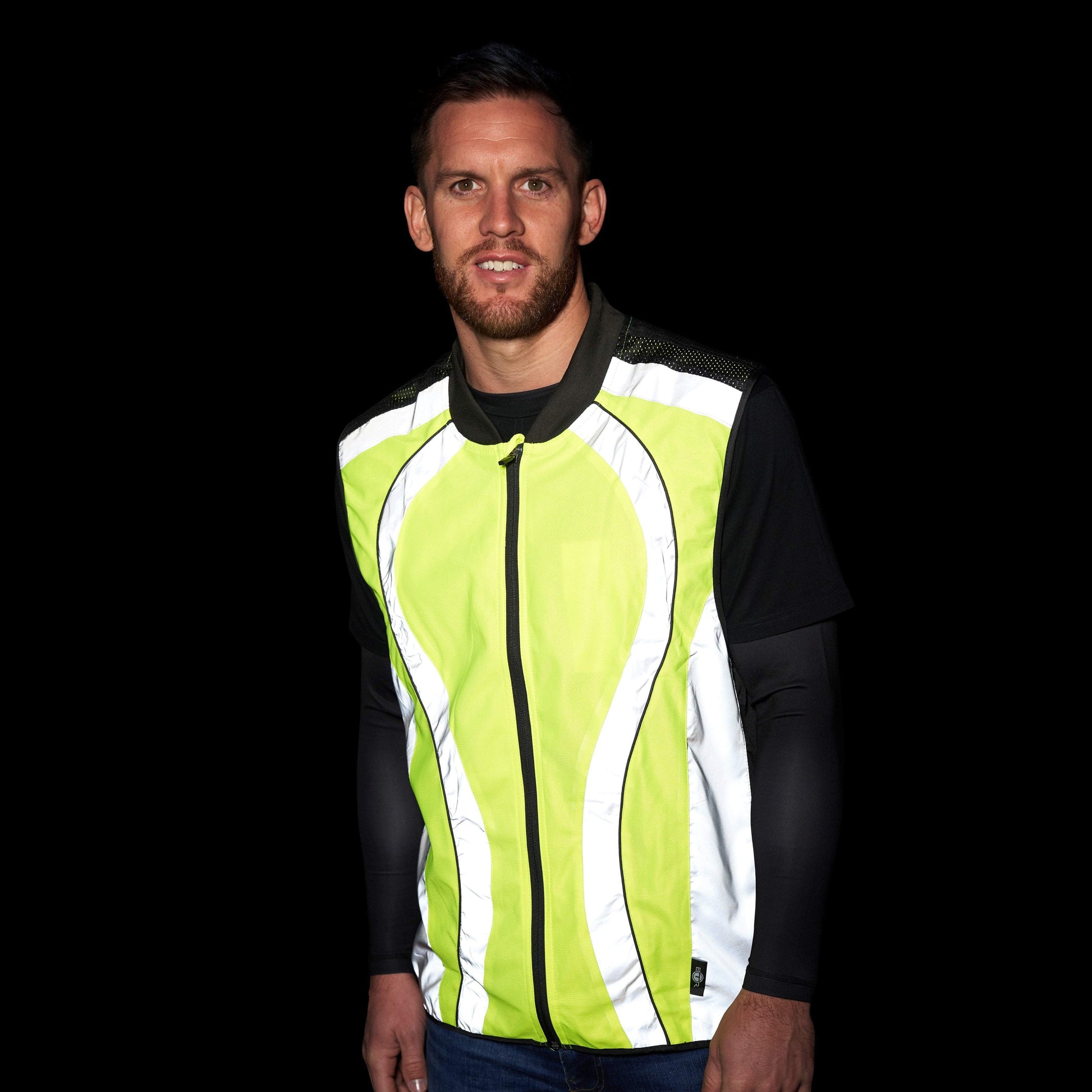 BTR yellow and silver gilet reflecting bright white in the dark, worn by a man